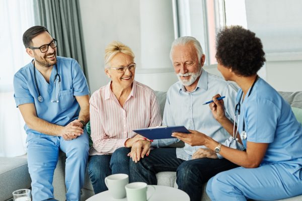 nurse doctor senior couple care caregiver help assistence retirement home nursing elderly man woman