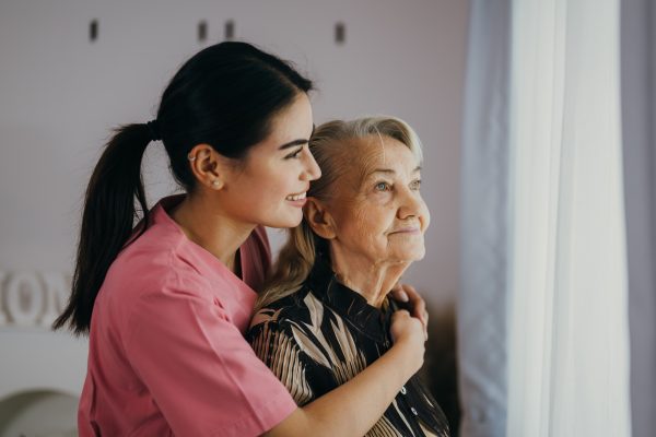 Senior patient with home care nurse, Happy senior woman talking with caregiver